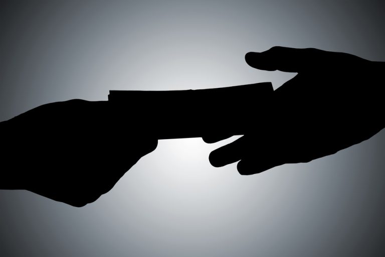 Silhouette,Of,Hands,Giving,Bribe,Against,Gray,Background
